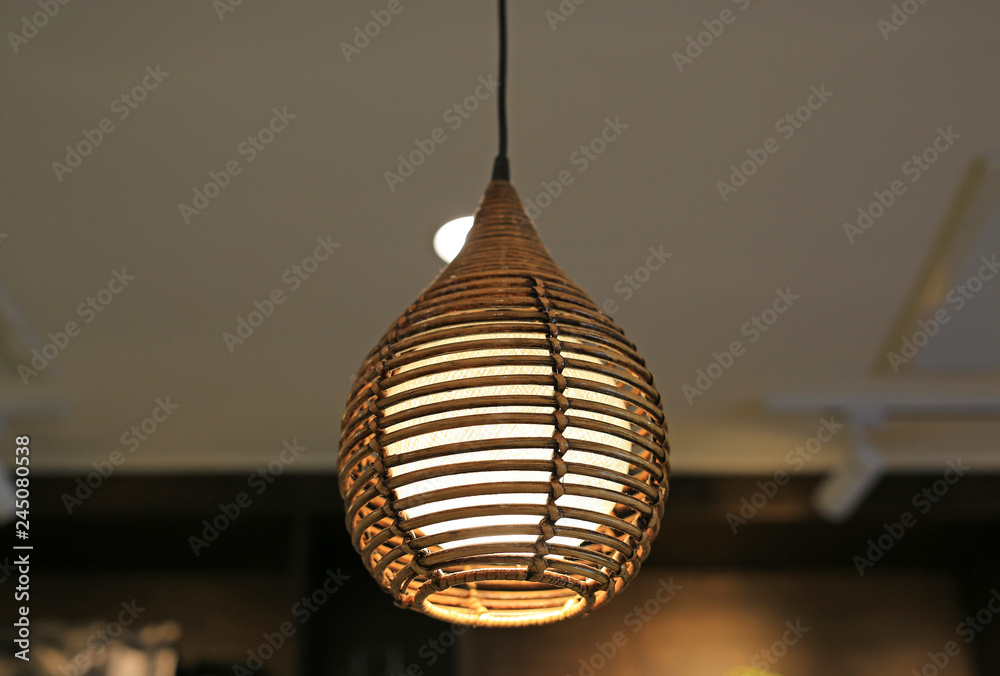 Obraz premium Wicker lamp hanging on ceiling