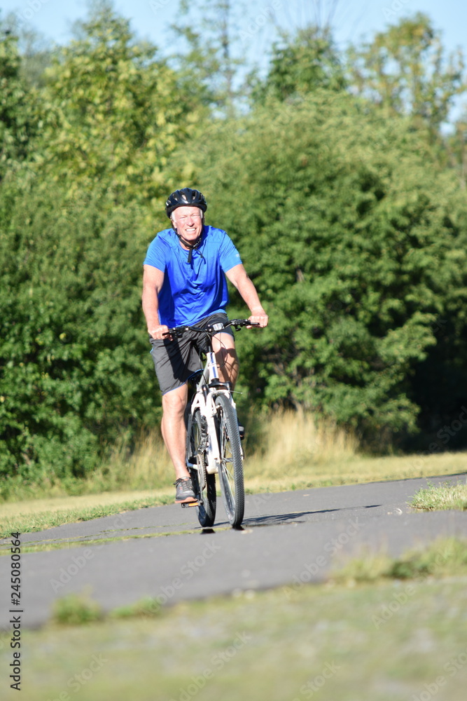 Happy Athlete Retiree Male Cyclist Riding Bike