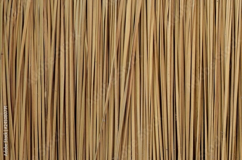 Background and texture photo of traditional asian house's Thatched wall or fence or roof that made from blady grass.