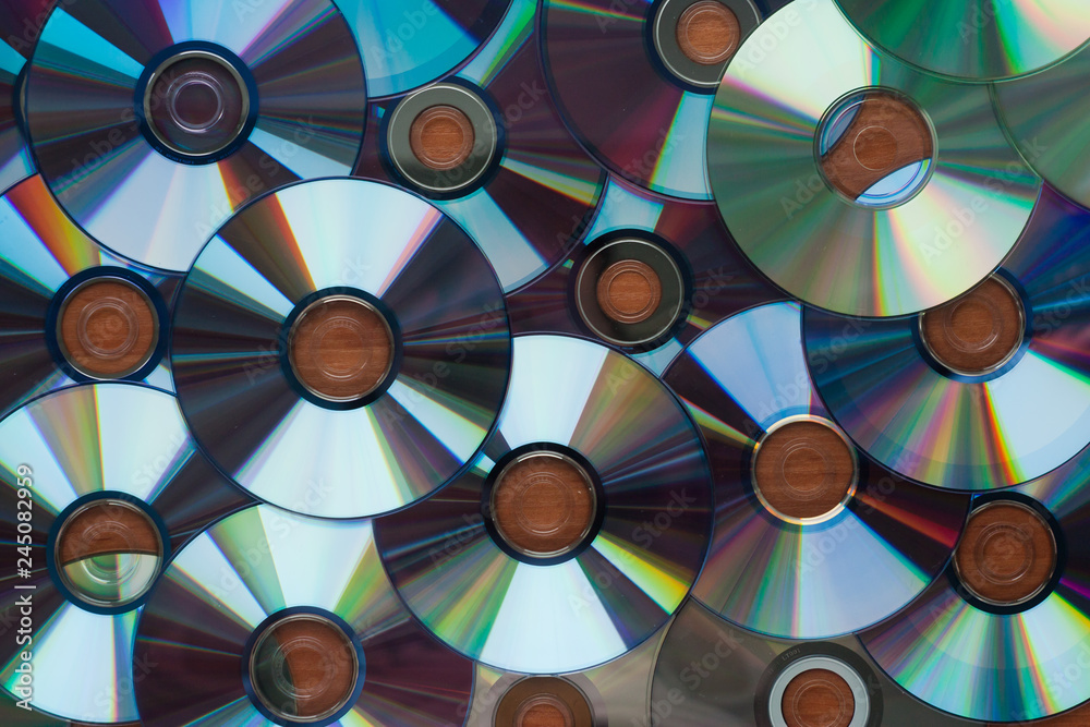 A lot of computer cd disks reflecting on a wooden surface, texture A lot of computer cd disks reflecting on a wooden surface, texture