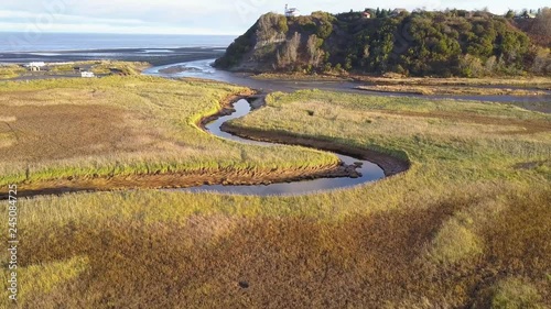 Beautiful aerial drone view of Deep Creek flowing alongside the cliff and into the vast Pacific Ocean in Deep Creek State Park in Ninilchik, Alaska photo