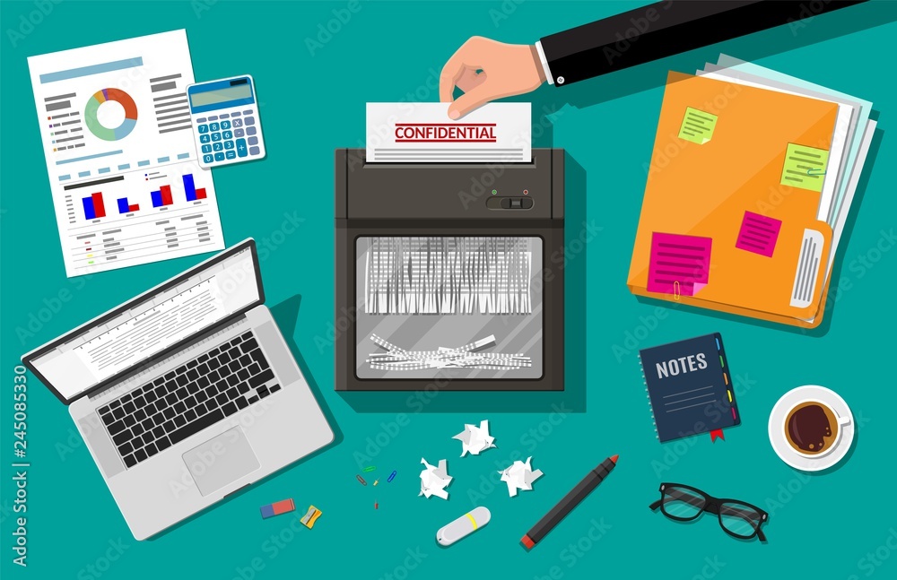 Hand putting paper in shredder machine.