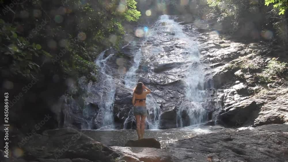 young girl on the background of the waterfall. Thailand Phang nga young girl on the background of the waterfall. Thailand Phang nga