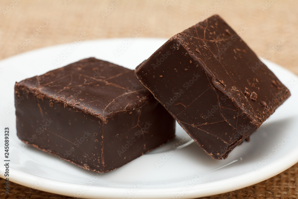 Chocolate candies rectangular shape put on white plate.