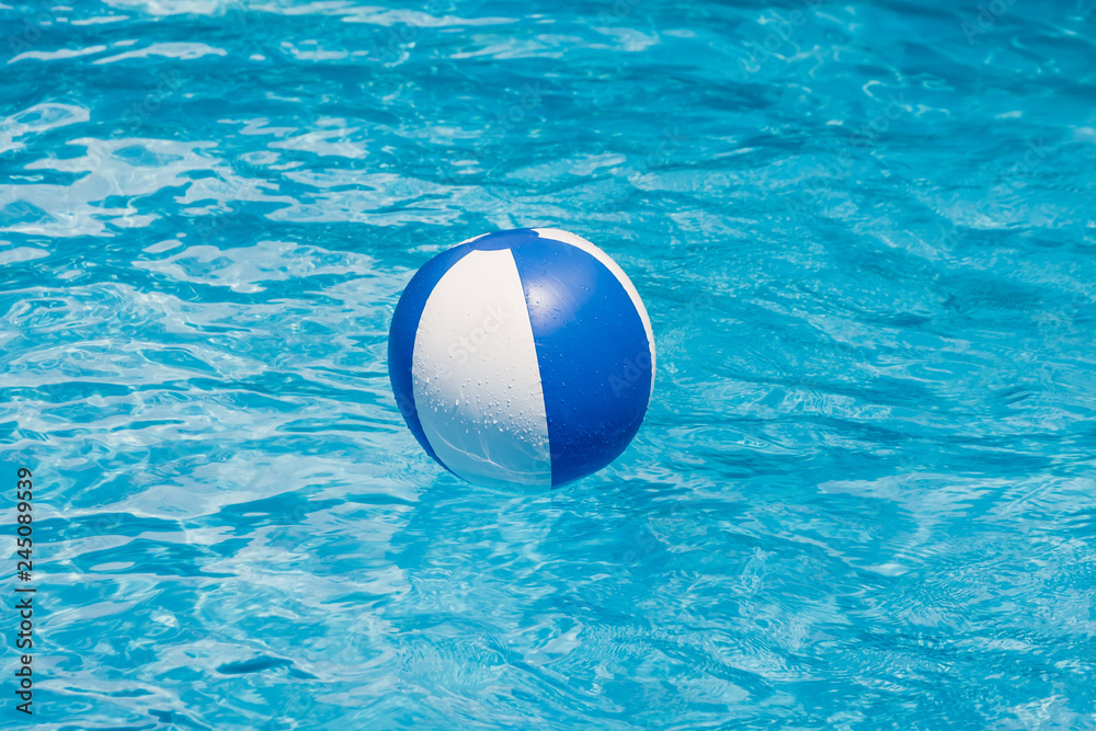 Inflatable colorful ball floating in a swimming pool