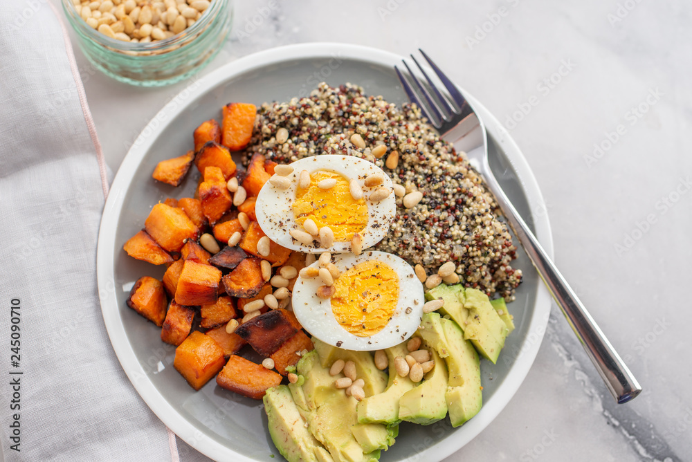 Quinoa salad in bowl with avocado