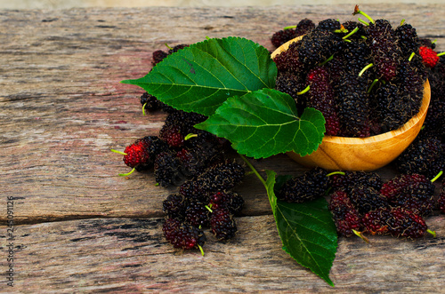 Macro close up of mulberries fruits in wooden bowl