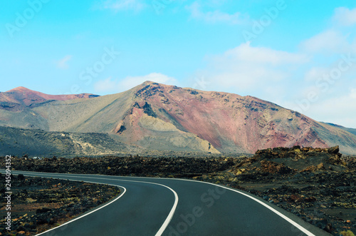 Road in Timanfaya National Park in Lanzarote,Canary Islands,Spain. The spectacular volcanic landscape background.