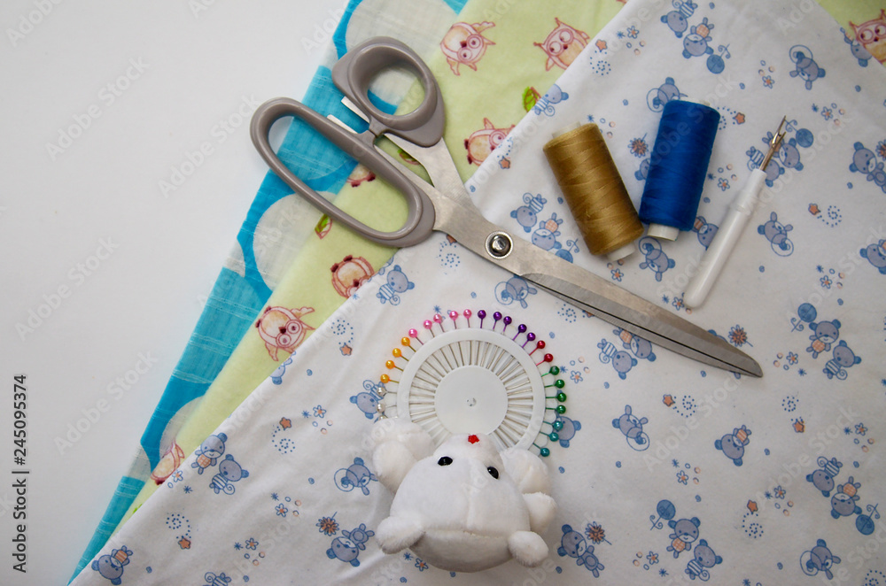 Obraz premium set for sewing different fabric products on a light background