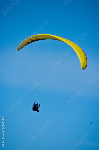 Paraglider in blue sky