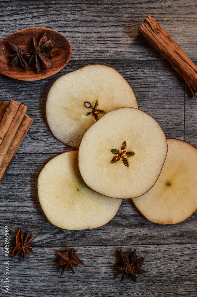 Star anise, cinnamon and apple on mader background. Star anise, cinnamon and apple on mader background.
