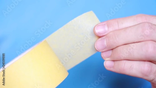 Adhesive tape in male hands closeup