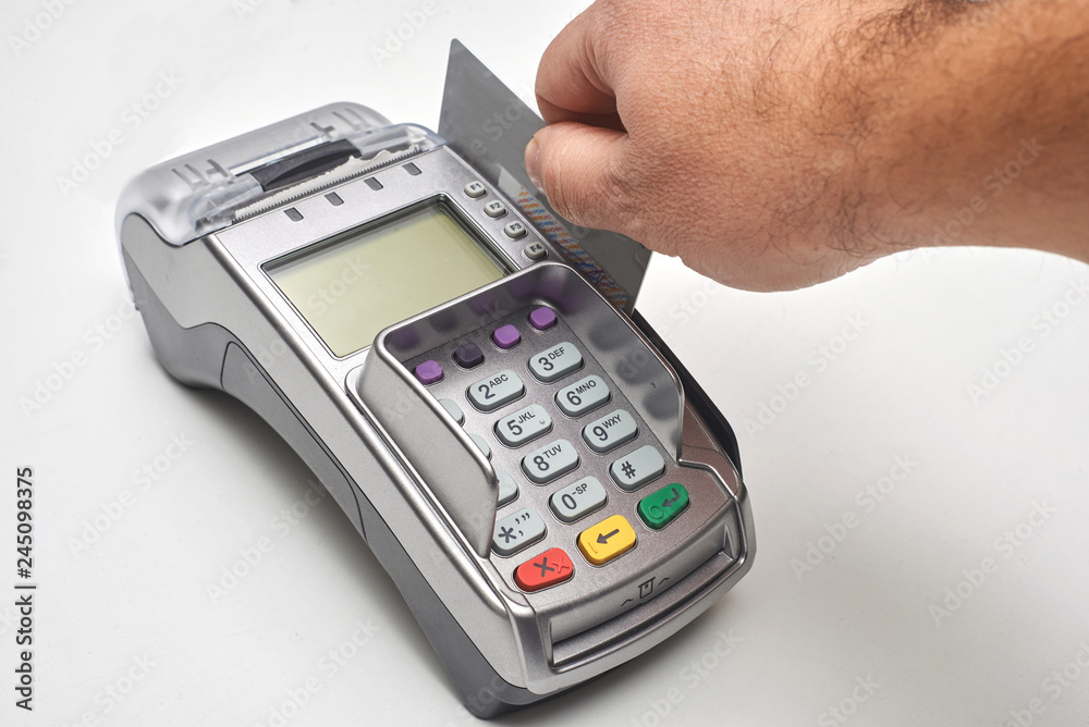 Businessman using payment terminal to pay with credit card. Businessman using payment terminal to pay with credit card.