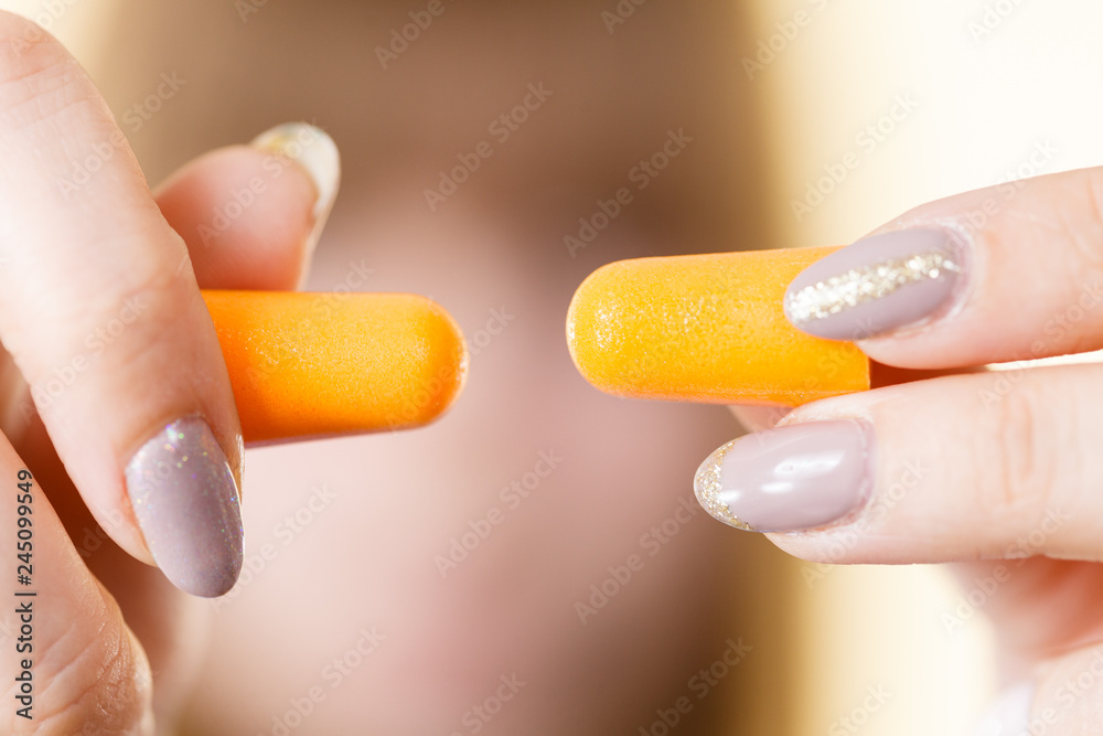 Woman holding protective earplugs Woman holding protective earplugs