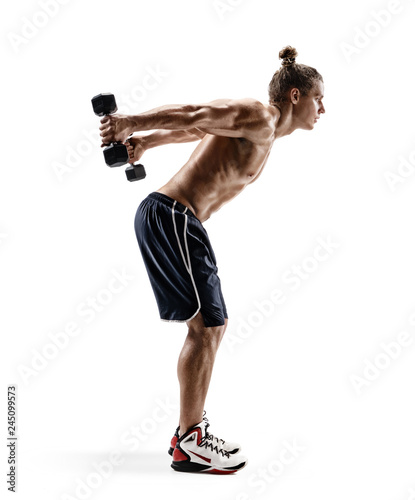 Sporty man doing exercises with dumbbells. Photo of man with naked torso isolated on white background. Strength and motivation. Side view. Full length