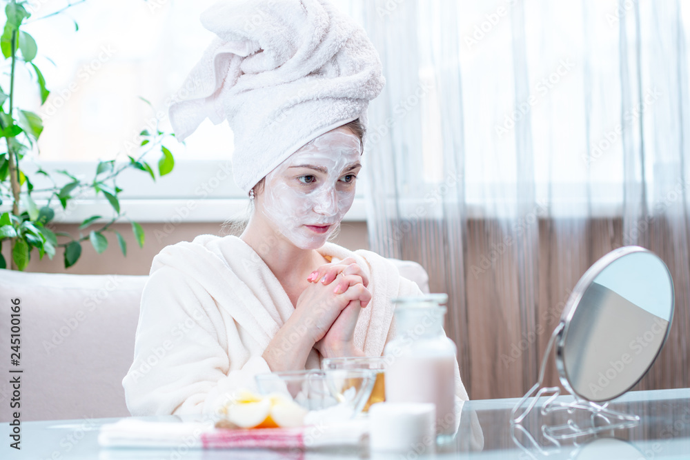 Beautiful happy young woman with natural cosmetic mask on face. Concept skin care and Spa treatments at home