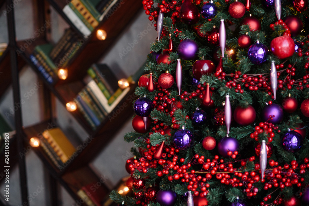 Winter decoration. decoration of the shelf for the new year or Christmas. candles, Christmas tree, books, bows and bumps Winter decoration. decoration of the shelf for the new year or Christmas. candles, Christmas tree, books, bows and bumps