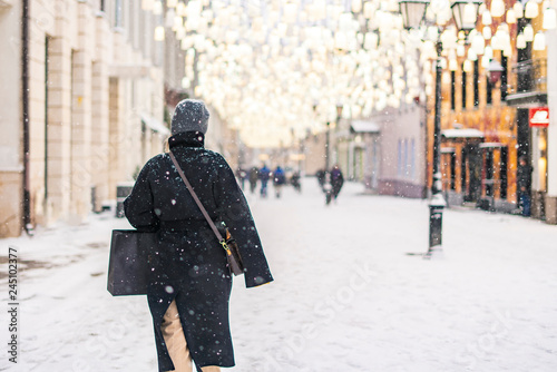 person walk in city streets in winter season under snowfall b
