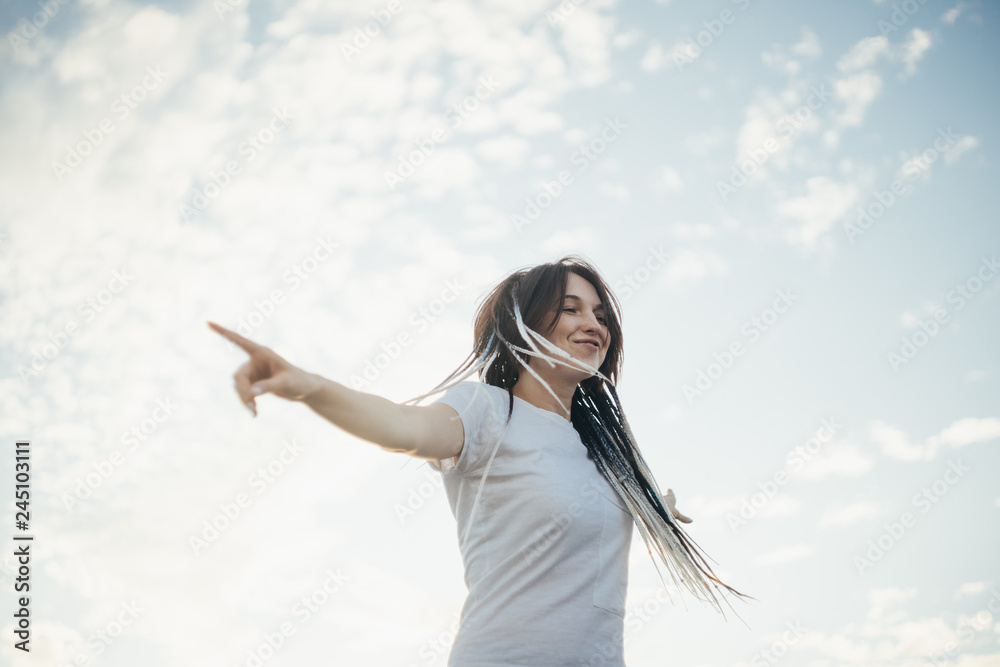 Happy smiling young woman in the city at the sunset Happy smiling young woman in the city at the sunset