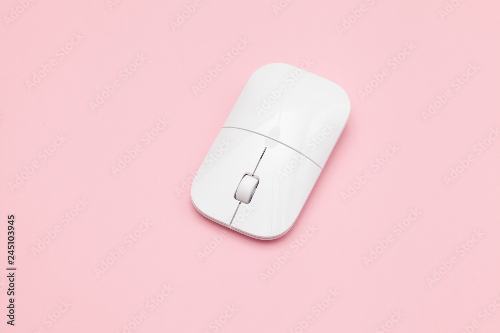 White wireless optical mouse with a wheel on a pink background. Modern concept for the Internet web site. Free space for input text, image, and logo. Mockup White wireless optical mouse with a wheel on a pink background. Modern concept for the Internet web site. Free space for input text, image, and logo. Mockup