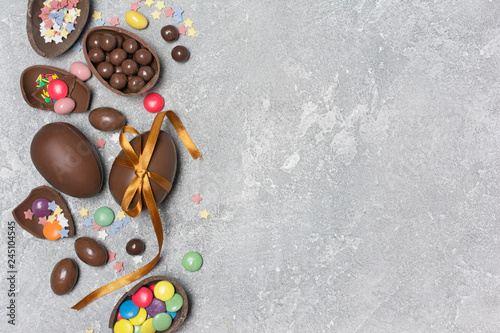 Chocolate traditional easter eggs with bright colorful dragee and sugar sprinkles with copy space