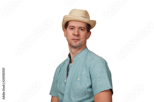 The man's portrait in a shirt and a hat on the head