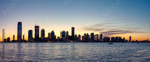 New Jersey silhouette panorama at dusk, view from New York City with Hudson River in foreground, USA.