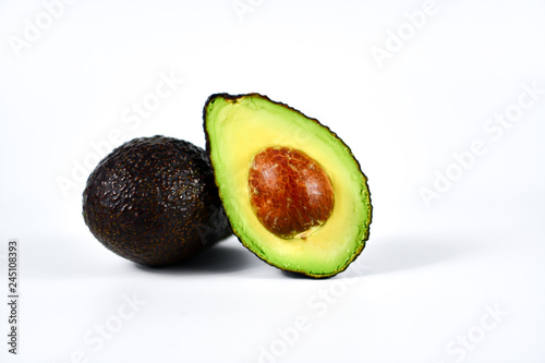 Fresh avocado cut in half with seed.