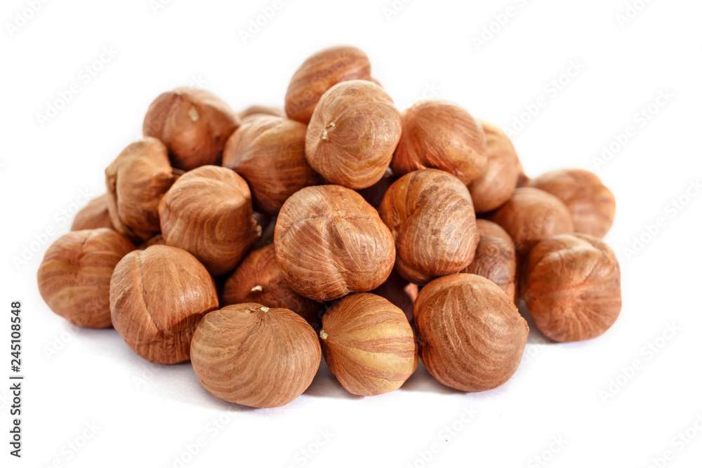 Peeled hazelnuts on a white background. Isolated hazelnut. Without shells. Peeled hazelnuts on a white background. Isolated hazelnut. Without shells.