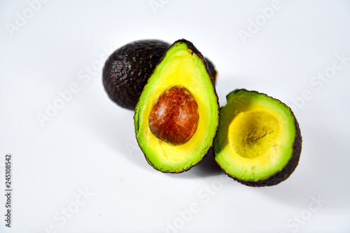 Fresh avocado cut in half with seed.