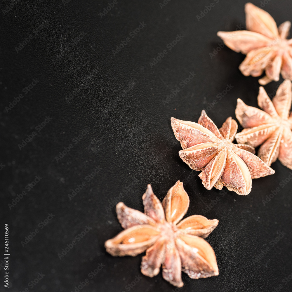 Asian spices, Star anise spice fruits and seeds isolated on black background closeup Asian spices, Star anise spice fruits and seeds isolated on black background closeup