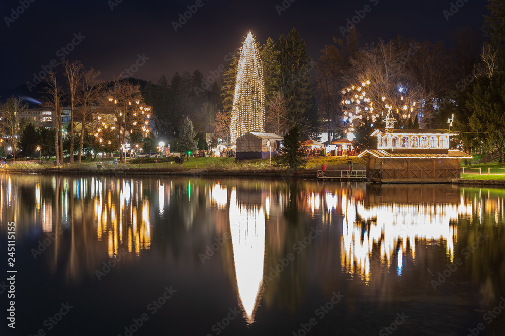 Night on Lake Bled. Christmas atmosphere and lights. Castle and Church of the Annunciation