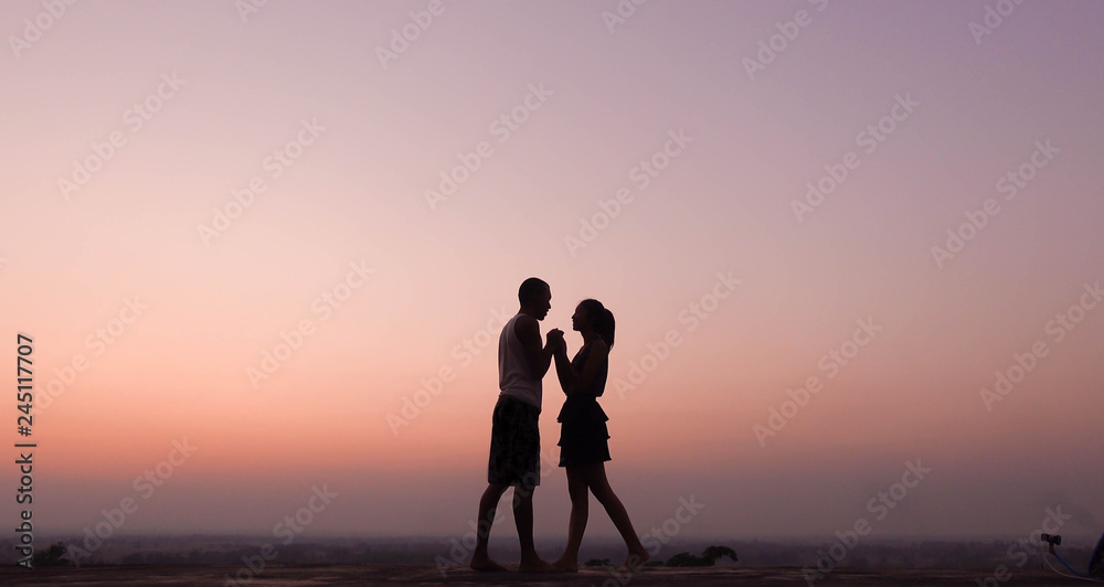 silhouette of couple felling love at sunset silhouette of couple felling love at sunset