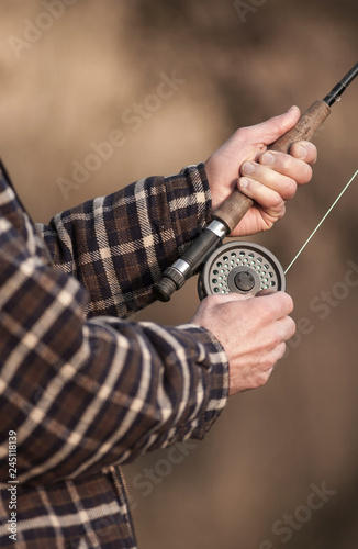 Hands tying flies and casting close up