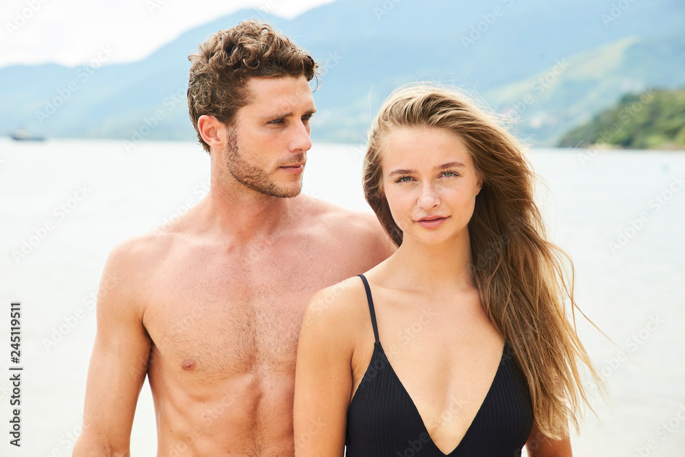 Good looking young couple on beach, portrait Good looking young couple on beach, portrait
