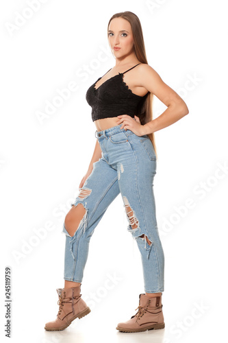 young woman with very long hair and jeans on white background