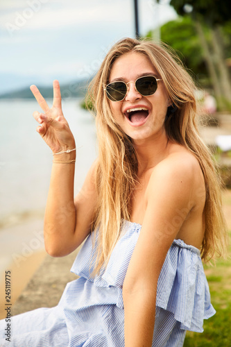 Posing pretty girl in shades at beach