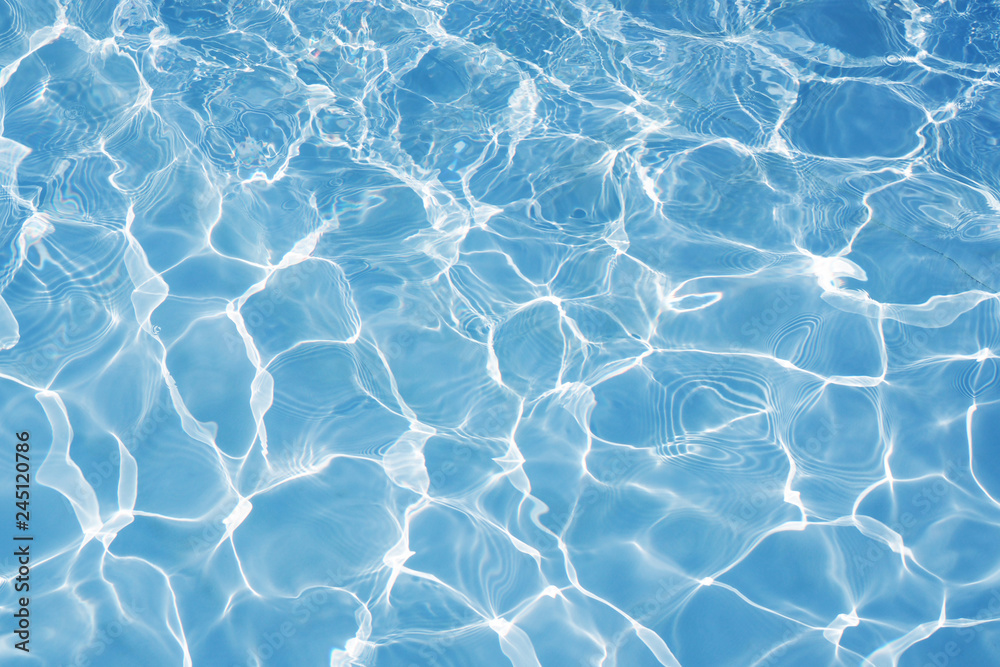 Blue water surface with bright sun light reflections, water in swimming  pool background Stock Photo | Adobe Stock
