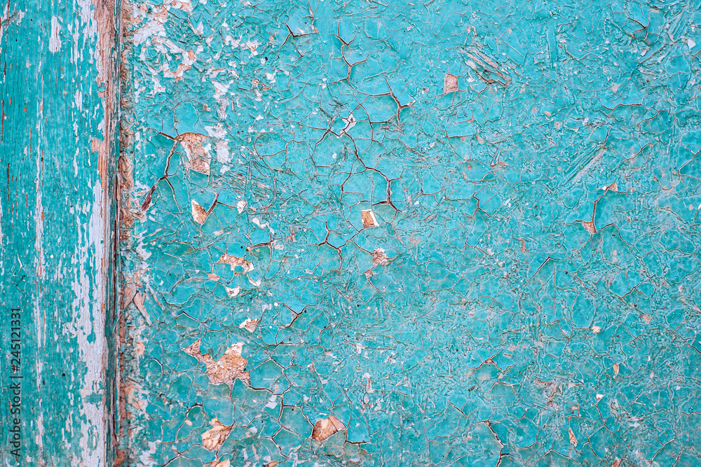 cracked blue paint on a wooden surface