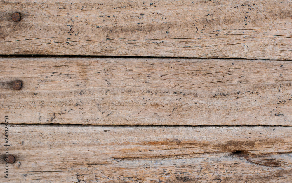 a wall of old wooden planks hammered in with nails a wall of old wooden planks hammered in with nails