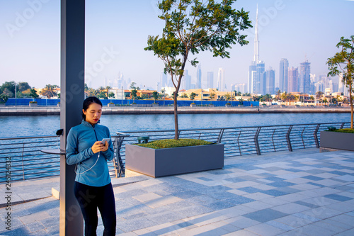 Canvas Print Female charging phone on a public charger