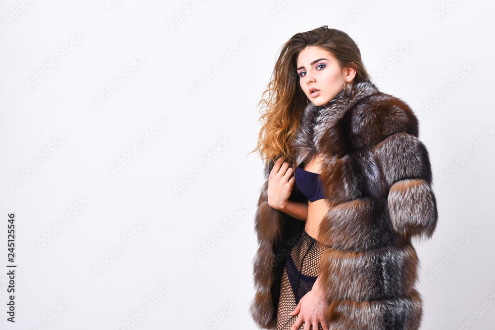 Girl temptress wear stockings and fur coat. Fashion boutique concept. Fashion for female. Elite clothes for sensual girl. Fashion luxury design. Woman tousled hairstyle posing lingerie and fur jacket Girl temptress wear stockings and fur coat. Fashion boutique concept. Fashion for female. Elite clothes for sensual girl. Fashion luxury design. Woman tousled hairstyle posing lingerie and fur jacket