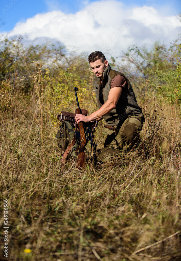 Prepare for hunting. What you should have while hunting nature environment. Man with rifle hunting equipment nature background. Recharge rifle concept. Hunting equipment and safety measures Prepare for hunting. What you should have while hunting nature environment. Man with rifle hunting equipment nature background. Recharge rifle concept. Hunting equipment and safety measures