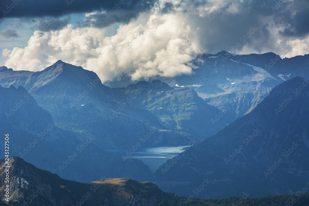 Landscape with Swiss alpine mountains with glaciers and sunset.