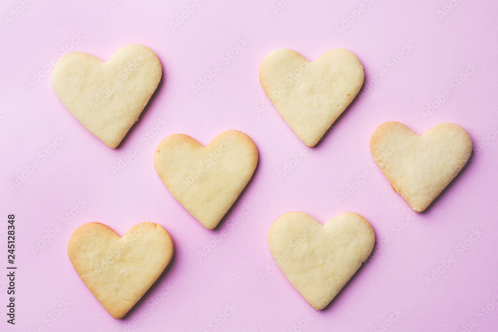 Homemade cookies in the shape of a heart on a pastel pink background. Copy space. Concept Valentine's Day Homemade cookies in the shape of a heart on a pastel pink background. Copy space. Concept Valentine's Day