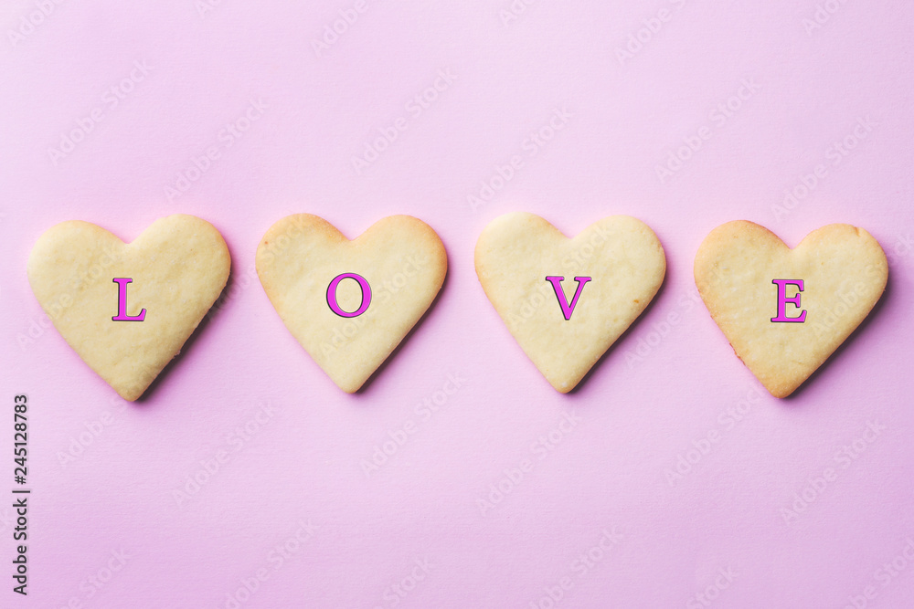 Homemade cookies in the shape of a heart on a pastel pink background. Copy space. Concept Valentine's Day Homemade cookies in the shape of a heart on a pastel pink background. Copy space. Concept Valentine's Day
