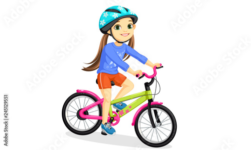 Happy little girl in helmet riding bicycle