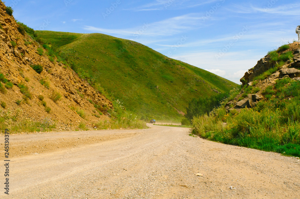 Dirt road between steep hills