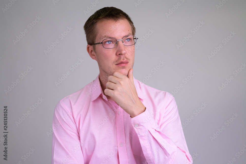 Face of young handsome businessman thinking with eyeglasses Face of young handsome businessman thinking with eyeglasses