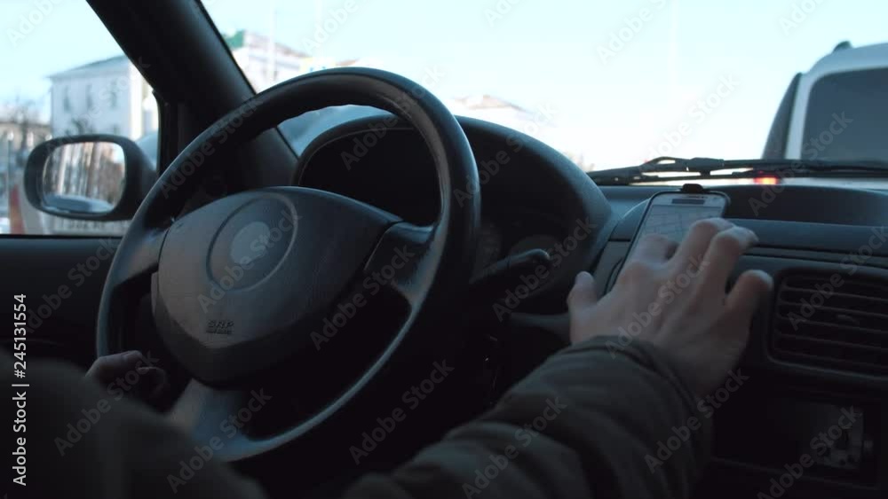 driver use smartphone in car. close-up. 4k. taxi driver at work. driver use smartphone in car. close-up. 4k. taxi driver at work.
